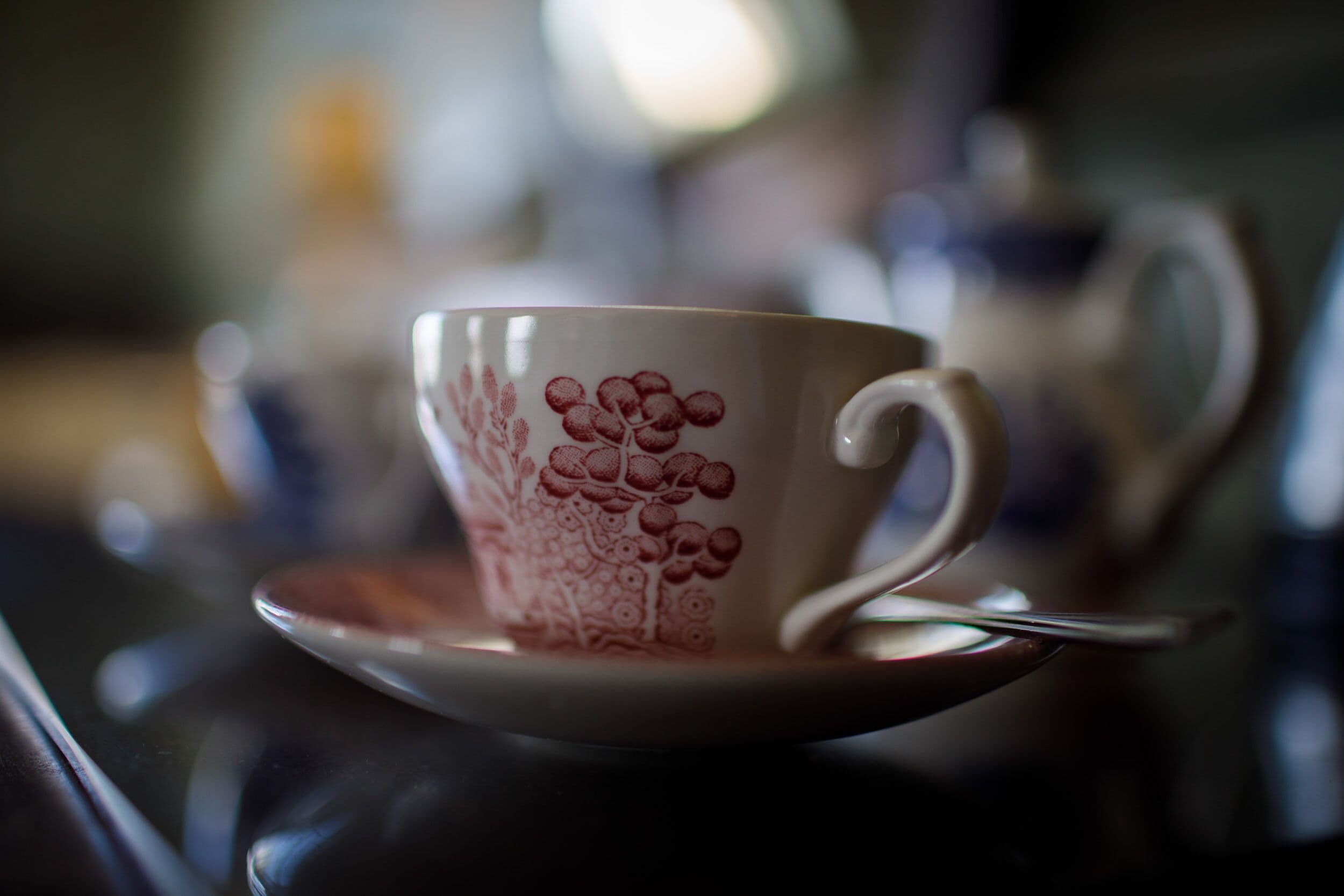 A close-up of a cup with a floral design on a saucer.