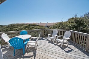 Relax on the deck with Adirondack chairs and a small table, taking in the serene views of the surrounding landscape.