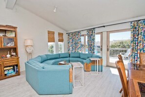 Relax in this inviting living room with a comfortable sofa, coffee table, and side table, perfect for unwinding and dining.