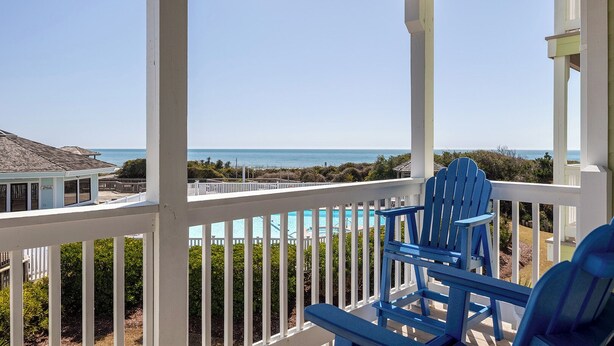 A balcony with a view of the ocean and a pool. - Pebble Beach A-207, Oceanfront Condo in Emerald Isle, NC! (Emerald Isle)