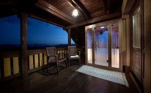 Enjoy breathtaking mountain views from this balcony with a glass door leading to the interior.