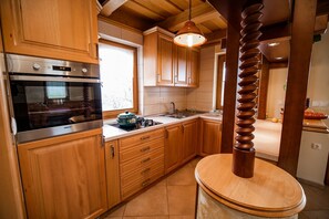 Enjoy cooking in this well-equipped kitchen with an oven, range, and sink.