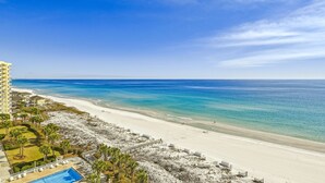 A beach resort with a pool, beach, and ocean view.