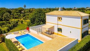 A two-story building with a swimming pool, outdoor seating, and a view of the surrounding greenery. - Villa Sol Nascente - Four Bedroom Villa, Sleeps 8 (Porches)