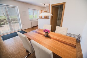 Enjoy meals in this dining area with a wooden table and comfortable chairs.