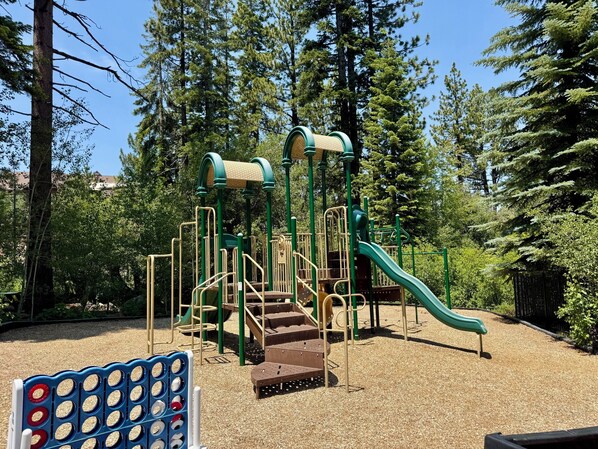 A playground with climbing structures, slides, and a ball pit. - Family Getaway | King Bed | Rec Center Access | Near Village, Trails & Lake (Truckee)
