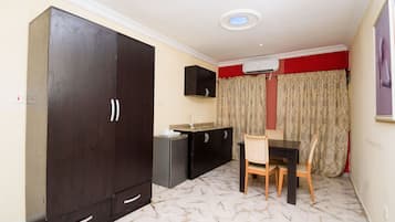 Premium Room | Living area | 32-inch plasma TV with cable channels