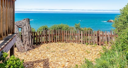 Dog-friendly, ocean-view cottage with private hot tub, deck, & free EV charger