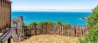 Dog-friendly, ocean-view cottage with private hot tub, deck, & free EV charger