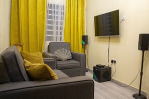 Standard Double Room | Living area | 32-inch Smart TV with satellite channels - Afua Oparebea Courts (Prampram)