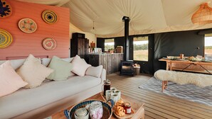 A cozy interior with a sofa, coffee table, and a dining area. - Foxley Lodge (Walsingham)