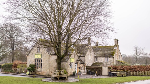 A stone building with a large tree in front, a bench, and a sign that reads "The." - Acorn Cottage, Bolton Abbey, Yorkshire Dales (Beamsley, Skipton)