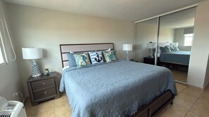 A bedroom with a bed, nightstands, a mirror, and a window. - 608 Ocean & Marina Views 3 Bedroom 2 Bathroom Luxury Condo (Fajardo)
