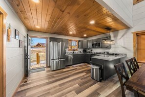 Enjoy cooking in this kitchen with a refrigerator, microwave, and large island with a sink.