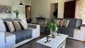 Basic Villa | Living area | 24-inch Smart TV with cable channels, Netflix, books