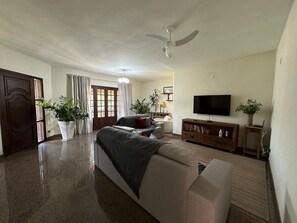 Basic Villa | Living area | 24-inch Smart TV with cable channels, Netflix, books