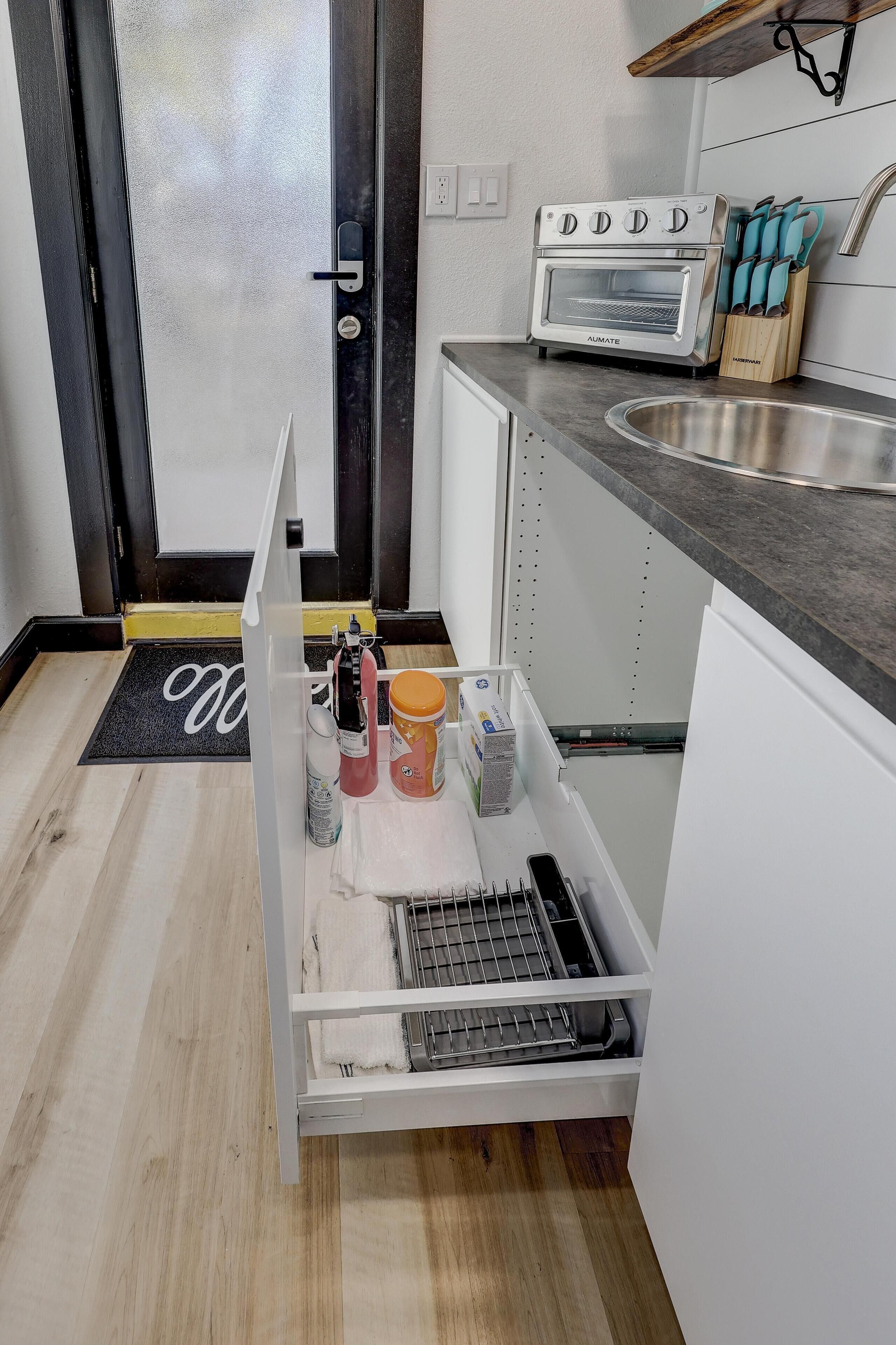 A kitchen with a built-in oven, a sink, and a countertop.