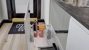 A kitchen with a built-in oven, a sink, and a countertop.