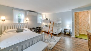 A bedroom with a bunk bed, a bedside table with a lamp, a small bedside table with a lamp, a wooden ladder, and a patterned rug. - Fire Pit & On-Site Pond: Wooded Walton Home! (Walton)