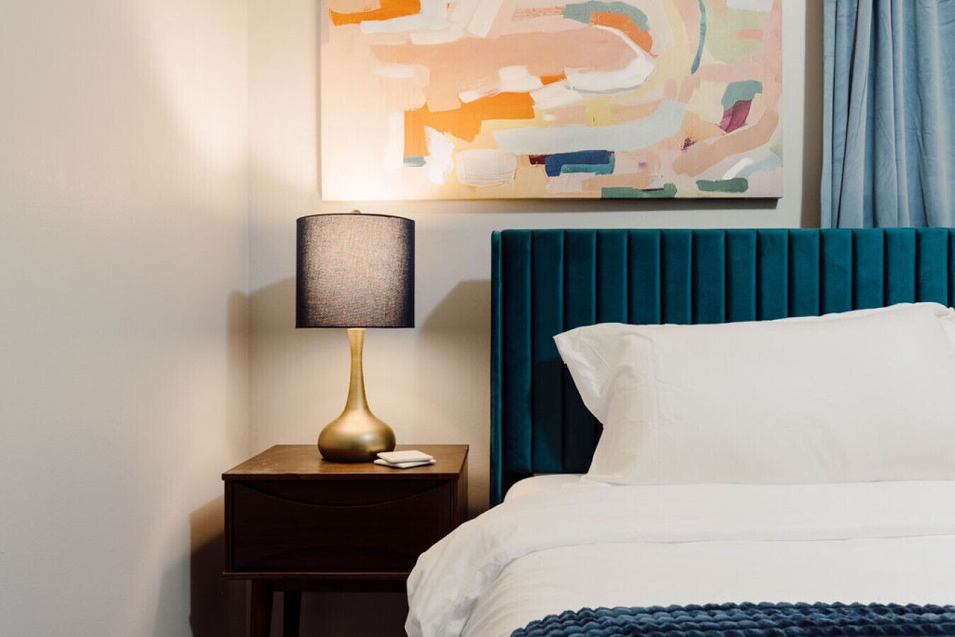 Right side of the bed with nightstand and lamp