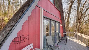 A red building with a deck, a glass door, and a fish mural. - Charming Franklin Cabin with Deck: Stunning Views! (Franklin)