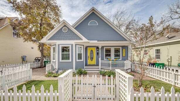 A two-story house with a gabled roof, a front porch, and a white picket fence. - Brenham Rental w/ Deck & Yard < 1 Mi to Downtown! (Brenham)