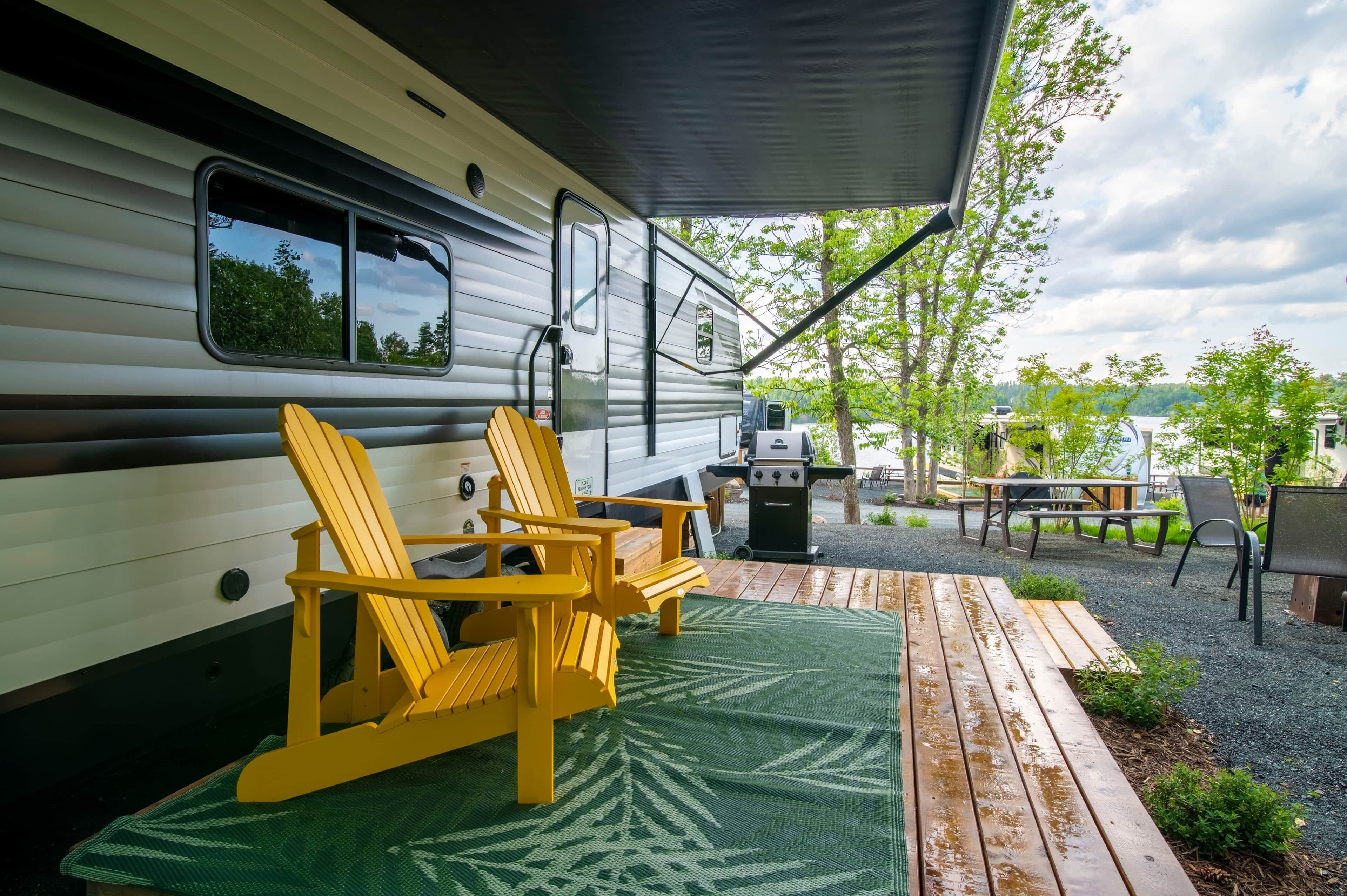 A covered outdoor area with a grill and seating.