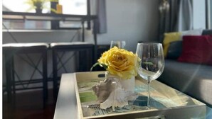 A dining area with a table set for two, featuring a yellow rose and an empty wine glass. - Brand New Modern Home /w Rooftop Downtown Skyview (Philadelphia)