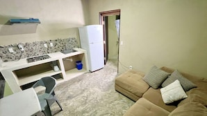 A compact living space with a kitchenette, a sofa, and a dining area. - #8 Tren Maya - Deluxe Family Room (Puerto Morelos)