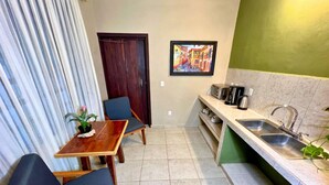 Una cocina compacta con comedor, un lavamanos y una puerta.