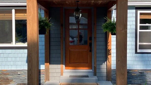 A house with a wooden front porch, a central door with glass panels, and two potted plants on either side. - The Winterbrook Mountain House.
Bike Week Garage Owls Nest Golf (Campton)