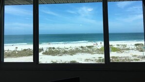 A room with a large window overlooking a beach. - AMI Beach + Gulf View Retreat - Dog-friendly (Bradenton Beach)