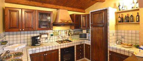 Fridge, stovetop, dishwasher, coffee/tea maker