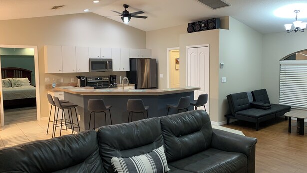 A modern living space with a kitchen, a dining area, and a seating area. - Charming 3-bedroom house in Englewood within minutes of beaches and golf. (Englewood)
