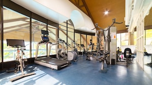 A gym with various exercise equipment, large windows, and a high ceiling. - Horseshoe Valley Suites - The Azure (Oro-Medonte)