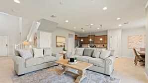A spacious living room with two sofas, a coffee table, and a rug. - Blissful Haven @ Windsor Westside by Shine Villas 995 (Kissimmee)