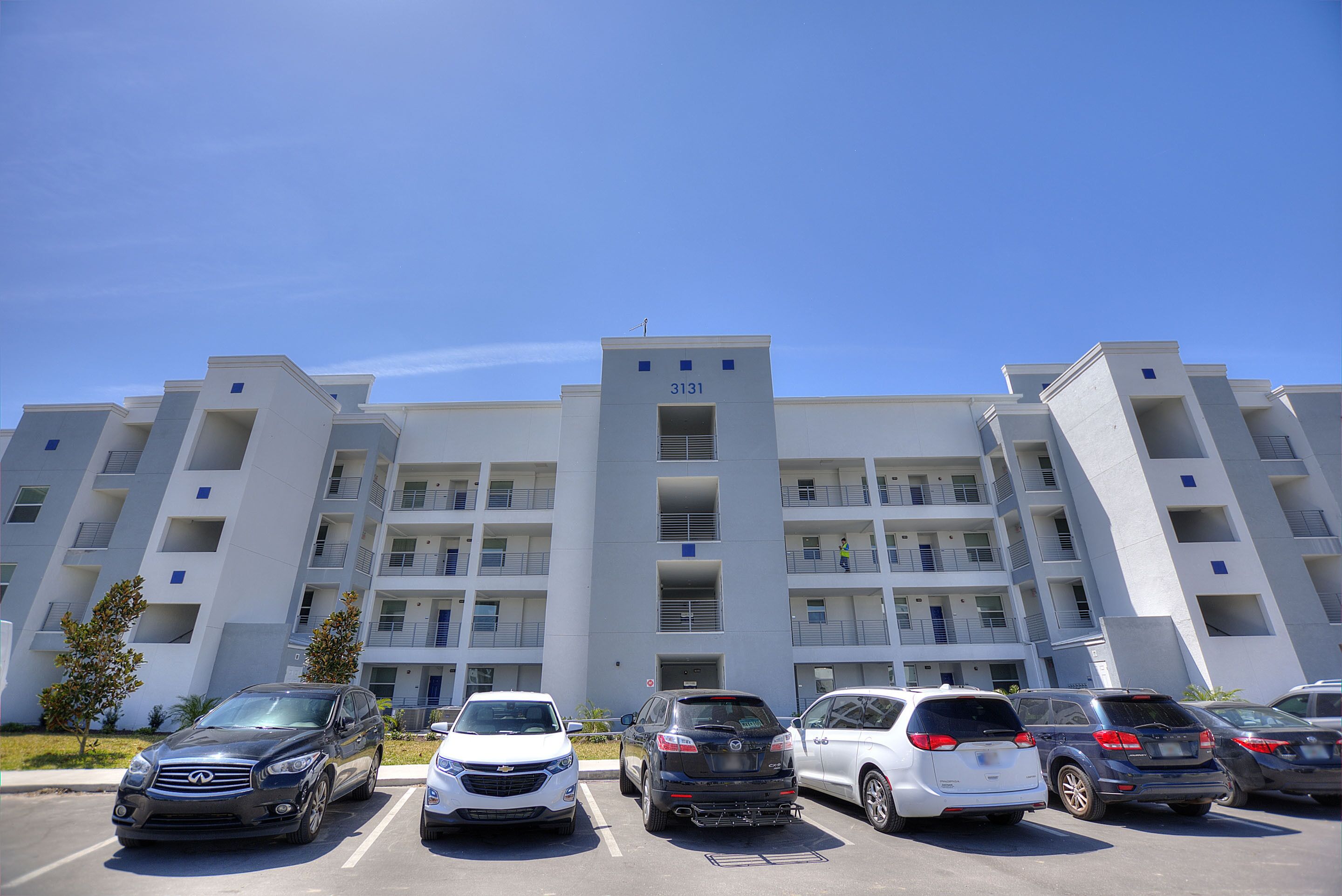 A multi-story parking garage with a modern design, featuring a prominent number '3131' on the facade.