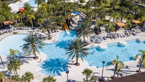 A large outdoor swimming pool with multiple lanes, surrounded by palm trees and lounge chairs. - Starstruck at Solterra Resort by Shine Villas #101 (Davenport)