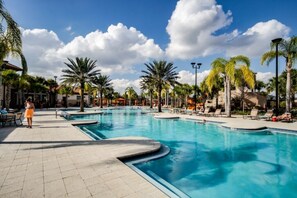 A large outdoor swimming pool with multiple lanes, surrounded by palm trees and lounge chairs. - Starstruck at Solterra Resort by Shine Villas #101 (Davenport)