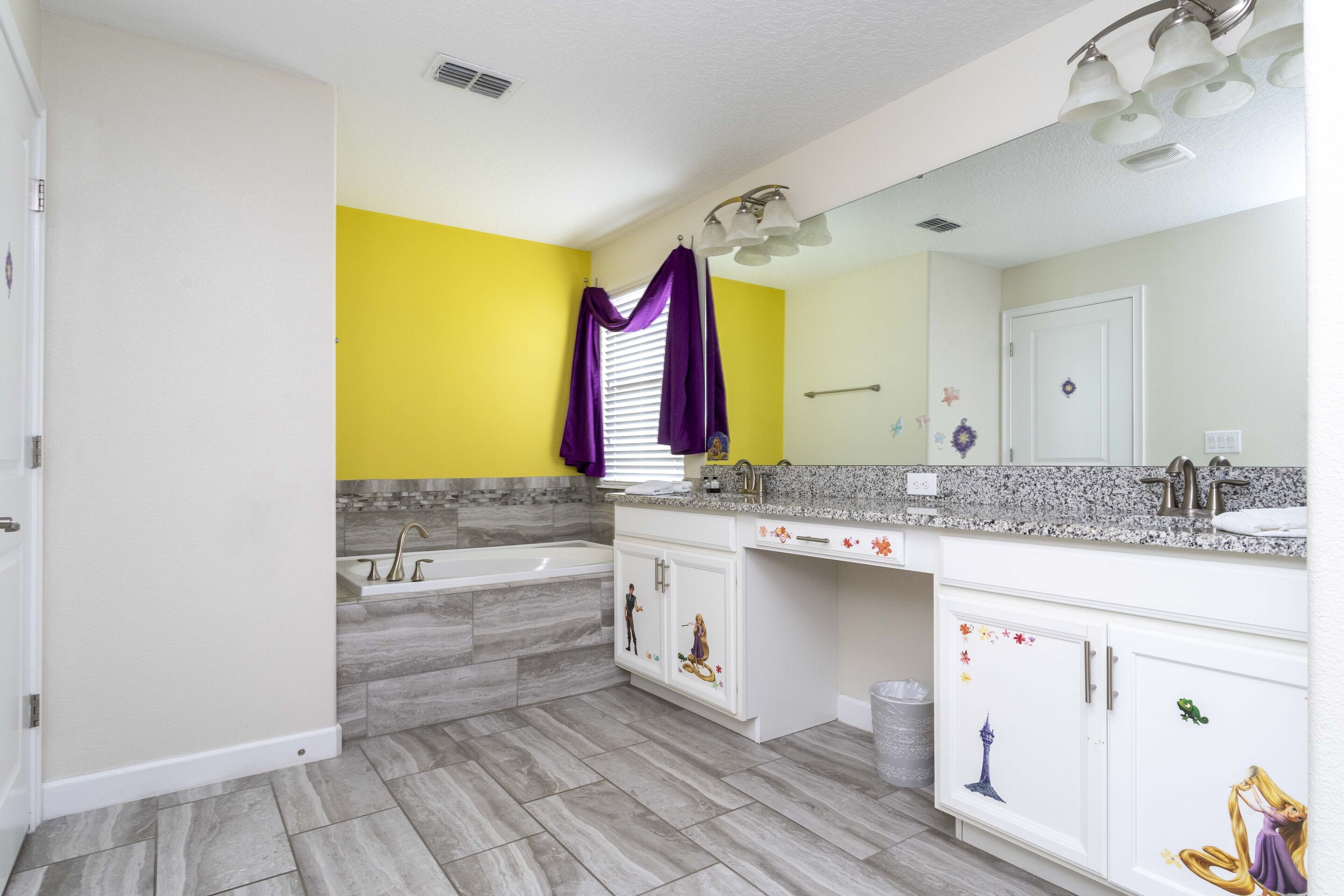 A bathroom with a bathtub, a sink, and a vanity with a mirror.