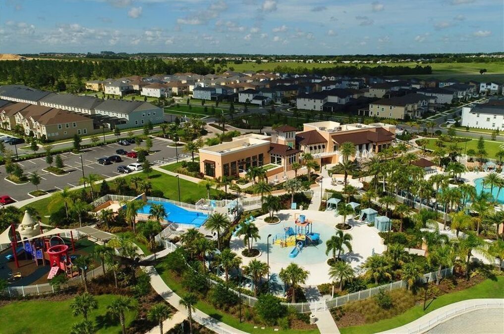 A residential area with a central swimming pool, playground, and landscaped areas.