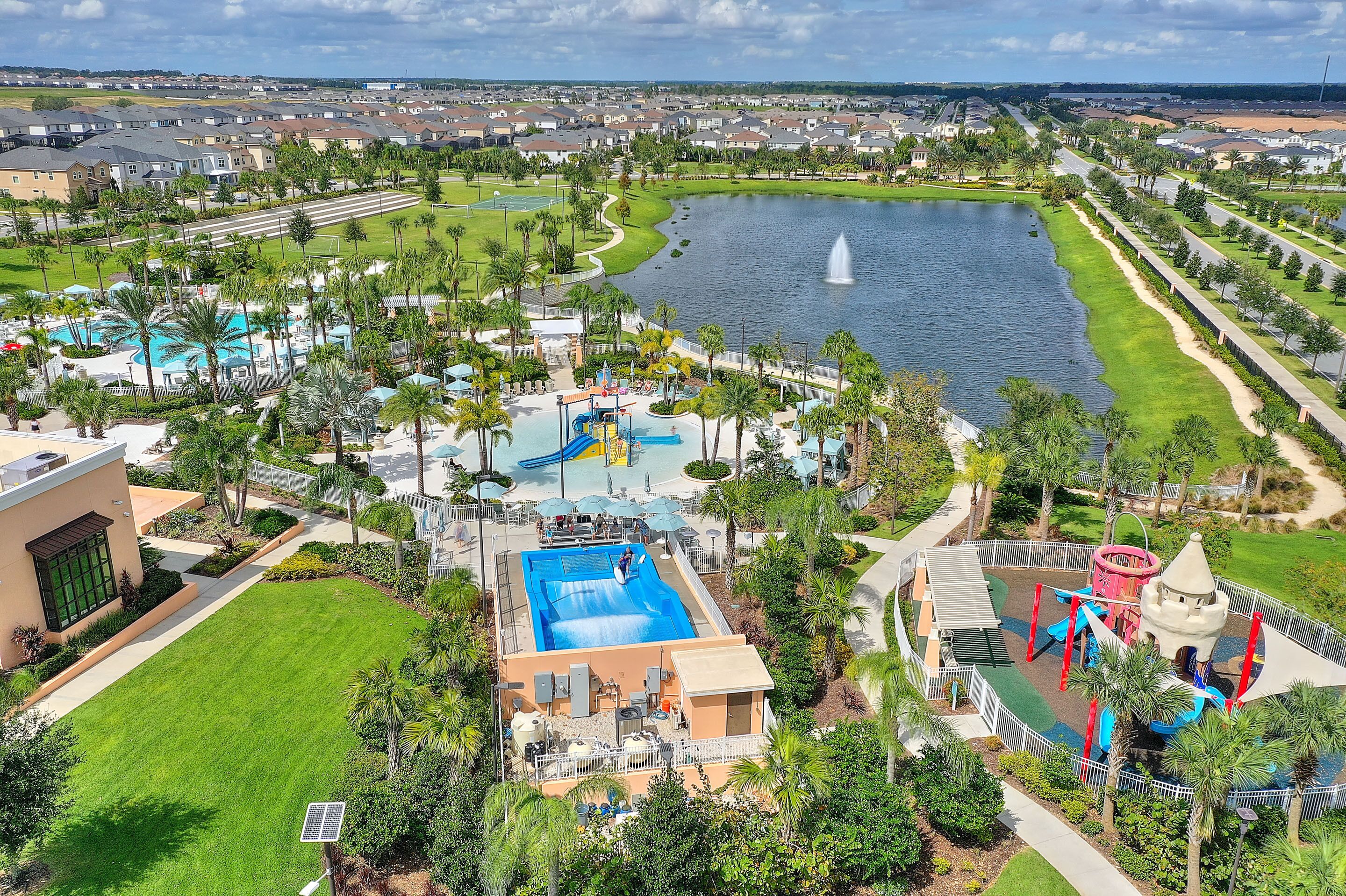 A resort with a swimming pool, water park, and a lake view.