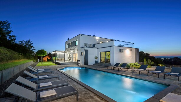A modern two-story house with a swimming pool, lounge chairs, and a covered patio area. - Stunning home in Vinogradi Ludbreski with sauna (Vinogradi Ludbreski)