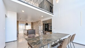 A modern dining area with a marble table, cushioned chairs, and a decorative vase. - Stunning home in Vinogradi Ludbreski with sauna (Vinogradi Ludbreski)