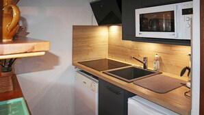 A compact kitchen with a microwave, dishwasher, and a small refrigerator. - APARTMENT N° 407 LE CAIRN (LES ORRES 1650)