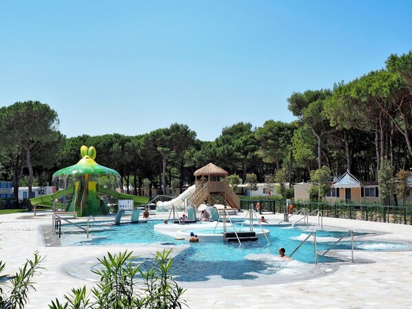 A water park with a large slide, a play structure, and a pool area. - Beautiful apartment in villa for 4 guests with pool, A/C, WIFI, TV and patio (Ca' Savio)
