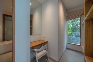 A modern bathroom with a wooden vanity, a large mirror, and a window with a view of greenery. - Dreamscape Haven  (Canggu)