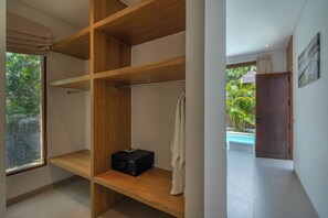 A modern bathroom with a wooden vanity, a towel rack, and a view of a swimming pool. - Dreamscape Haven  (Canggu)