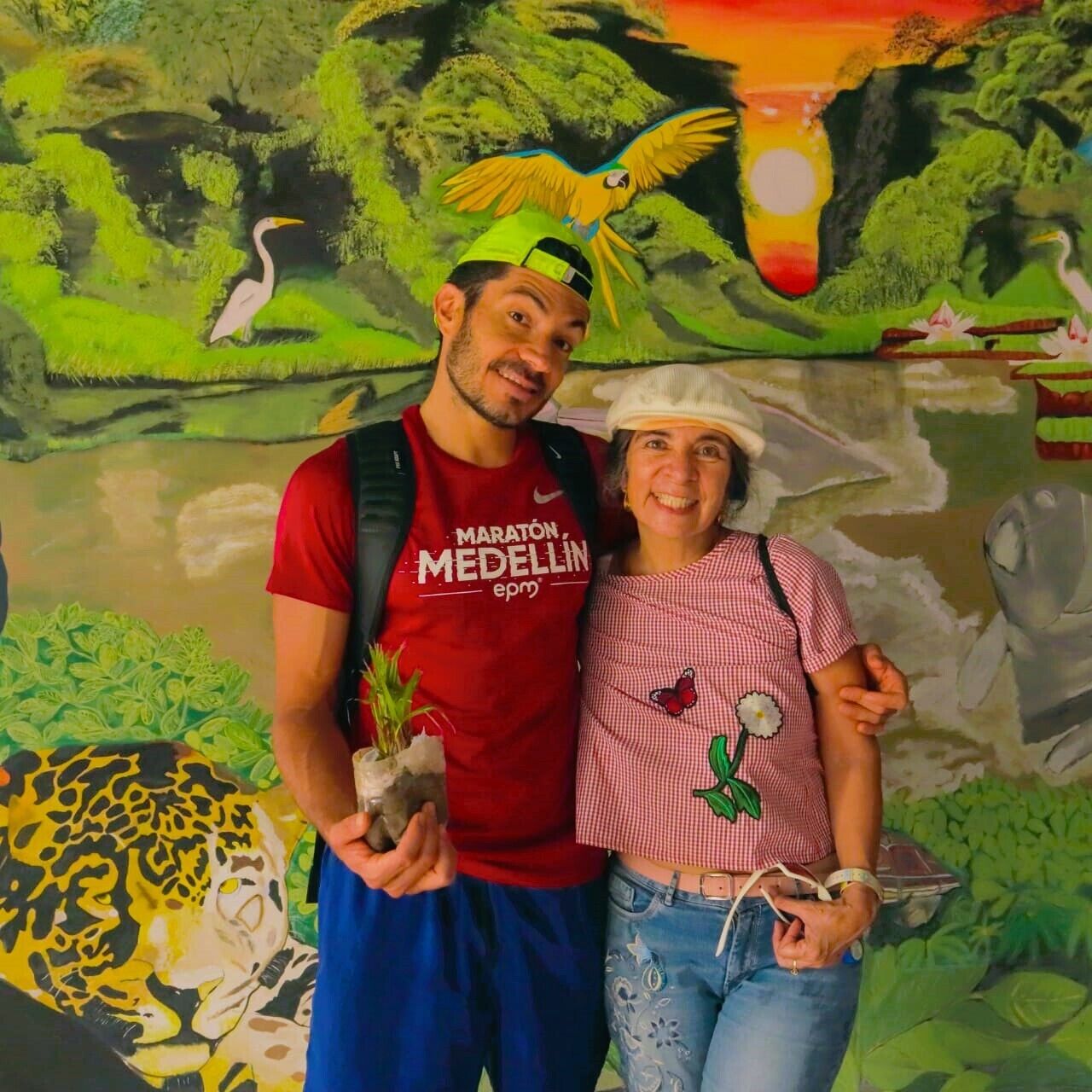 A mural with a bird, a jaguar, and a sunset.