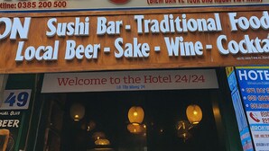 A hotel with a travel booking office, sushi bar, and a 24/7 welcome sign. - TUAN CENTRAL HOTEL (Hanoi)